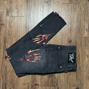 Black skinny jeans with orange and yellow zombie hand design